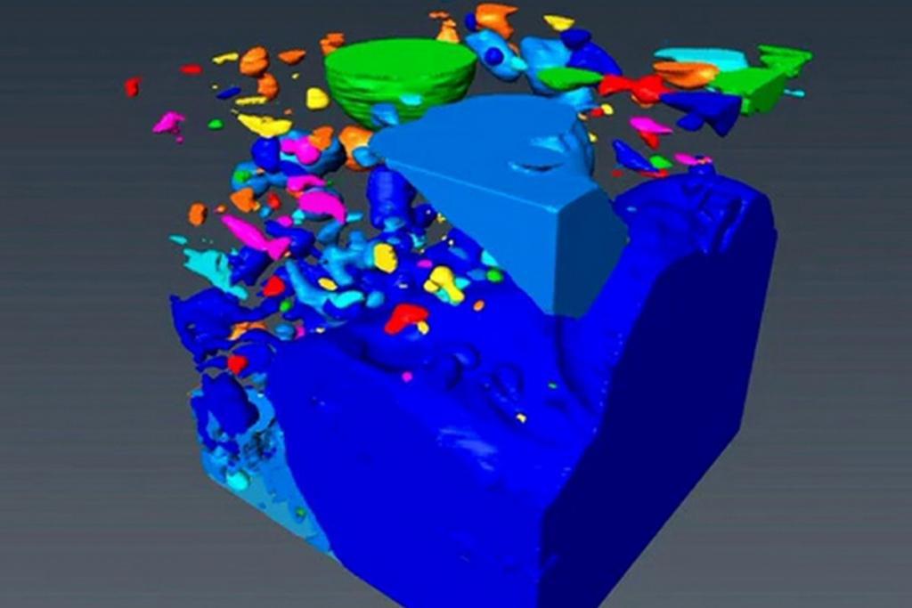 A cube-shaped sample of pumice (blue-gray) and pockets of trapped gases (other colors) - see also Video (link at end of text) 
(c) Berkeley Lab, UC Berkeley